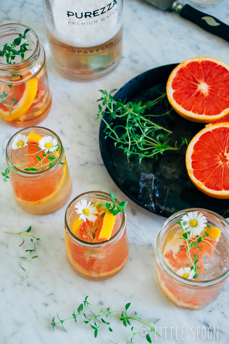 Alcoholvrije cocktail met sparkling water, rozensiroop, grapefruit en tijm